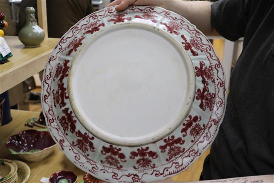 A pair of Chinese Ming-style underglaze copper red dishes, with wooden stands D.44cm